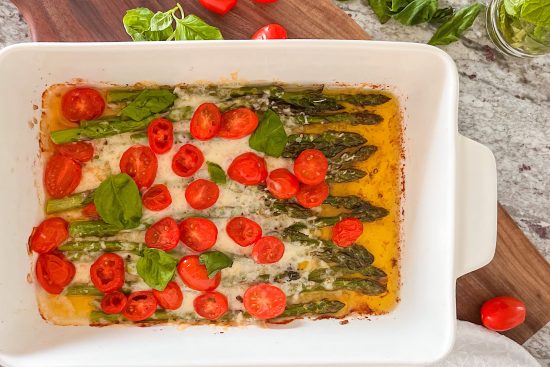 Baked Asparagus with Cheese, Cherry Tomato and garnished with fresh basil